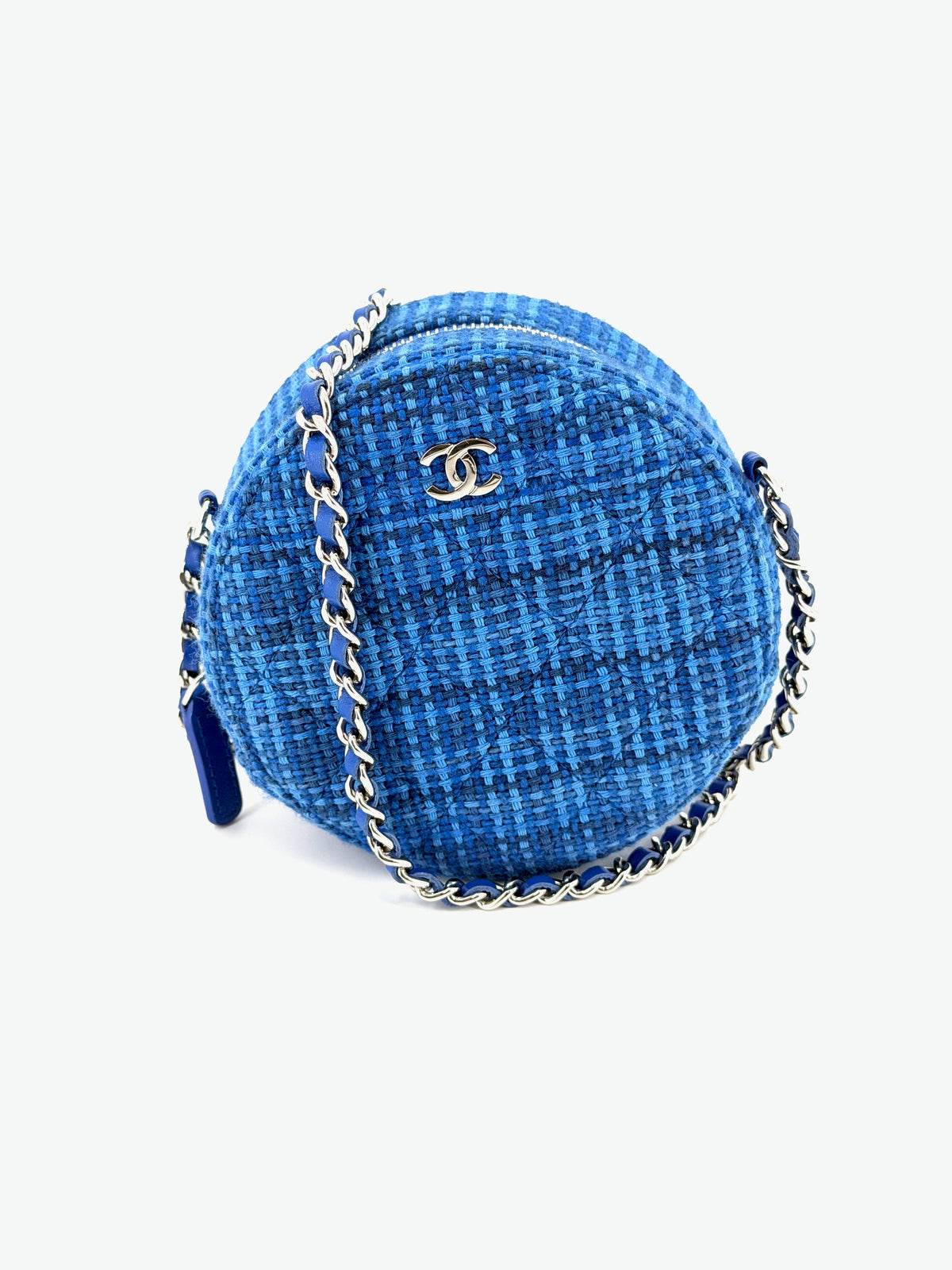 Authentic Chanel Mini Round crossbody bag in textured blue woven tweed with silver-tone CC logo, circular silhouette, zipper closure, and blue leather-interwoven chain strap.
