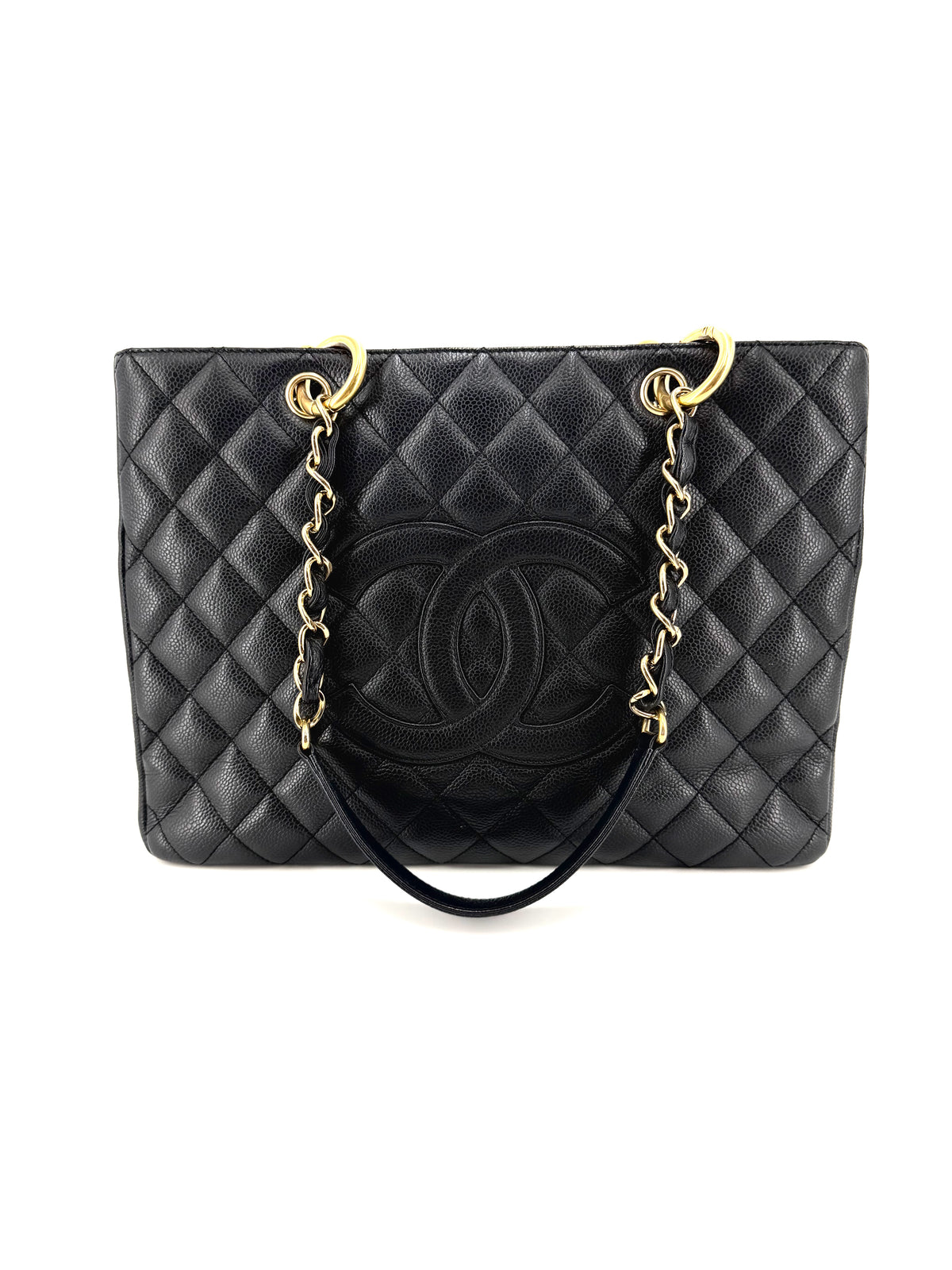 Chanel Grand Shopping Tote (GST) in black quilted caviar leather with gold-tone hardware, interlocking CC logo, and chain shoulder straps.